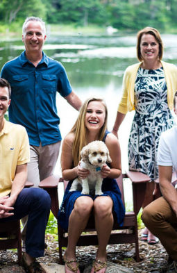 Dave Keil smiling alongside his family in front of a lake