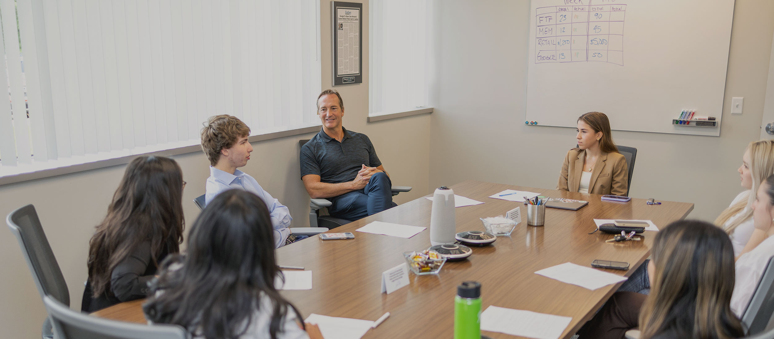 John Rotche talking to a group of interns in the conference room